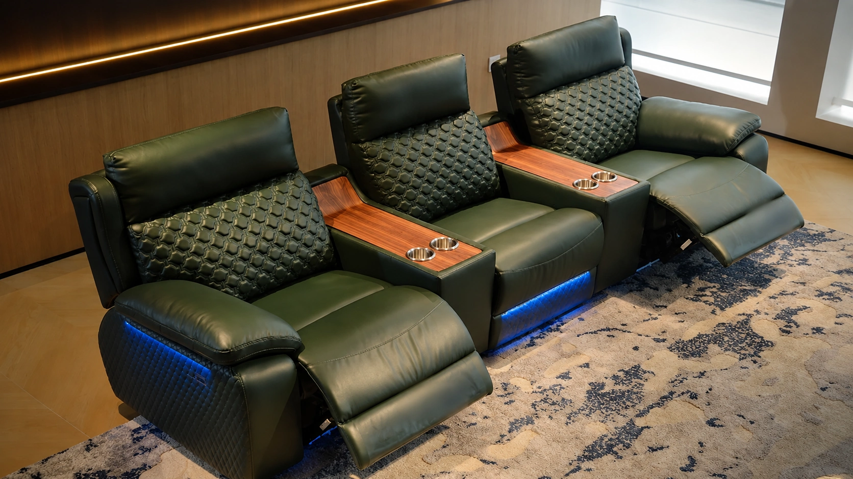 Walnut Row dark green cinema seating with warm wood console accents